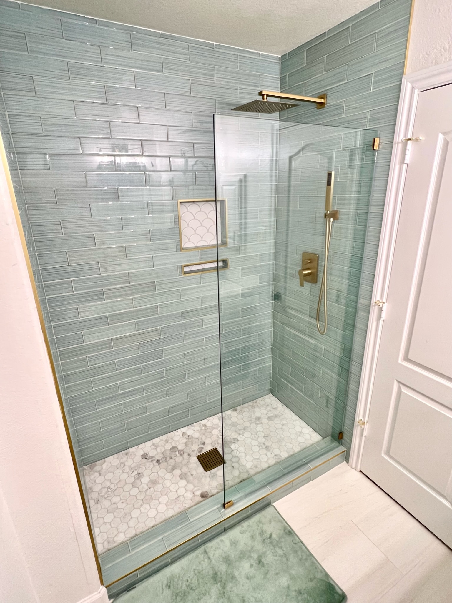 light blue tile shower install with custom shower glass, wfa's custom hardwood floors, houston texas